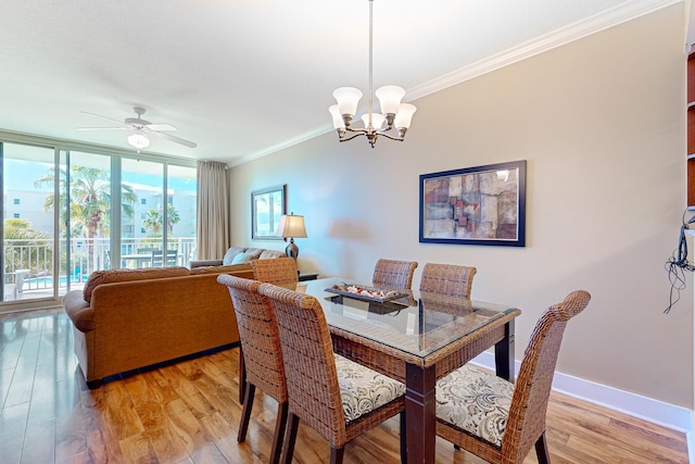 dining room featuring a wall of windows, crown molding, light wood-style floors, and baseboards