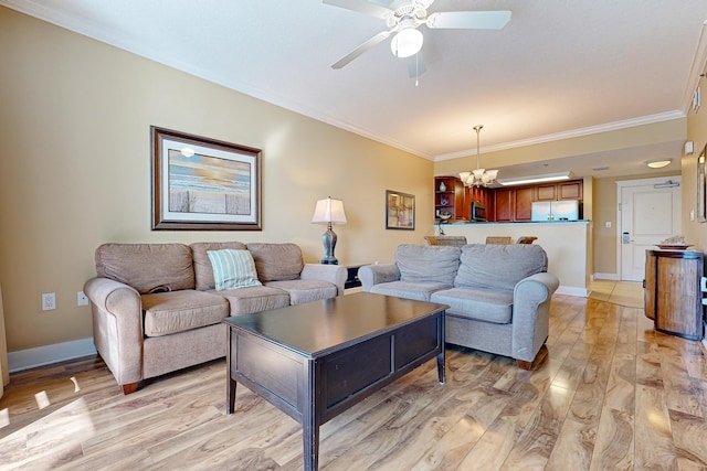 living area with ceiling fan with notable chandelier, light wood-style floors, baseboards, and ornamental molding