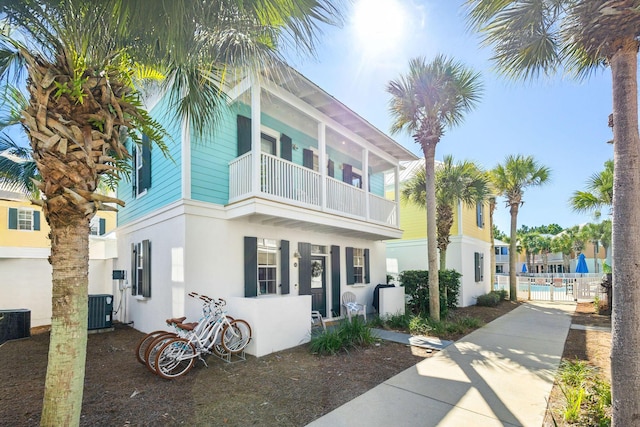 198 Somerset Bridge Rd Unit 120, Santa Rosa Beach, FL 32459 - view of front of home featuring stucco siding, central air condition unit, a gate, fence, and a balcony