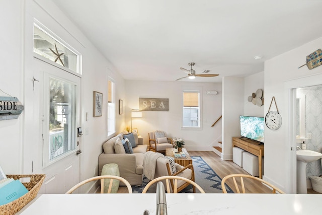 198 Somerset Bridge Rd Unit 120, Santa Rosa Beach, FL 32459 - living area with light wood finished floors, stairway, a healthy amount of sunlight, and a ceiling fan