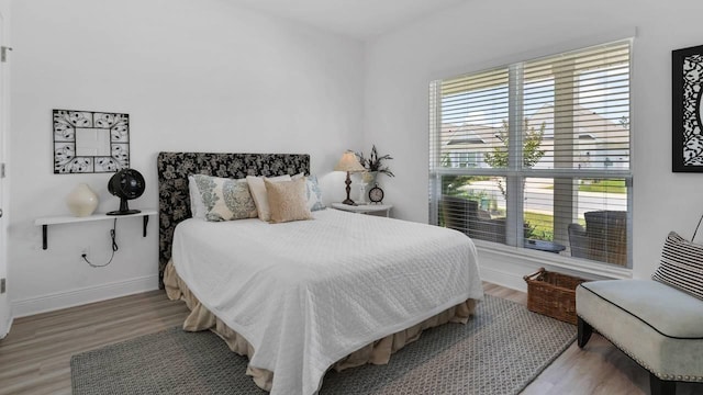 33 Spoonbill Rd, Santa Rosa Beach, FL 32459 - bedroom with multiple windows, baseboards, and wood finished floors