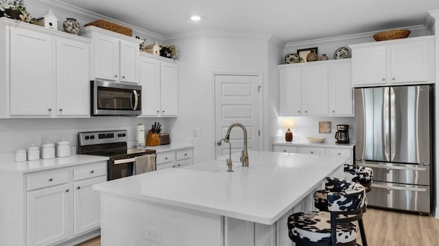 33 Spoonbill Rd, Santa Rosa Beach, FL 32459 - kitchen with a sink, white cabinetry, stainless steel appliances, crown molding, and light countertops