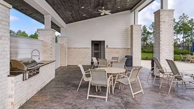 33 Spoonbill Rd, Santa Rosa Beach, FL 32459 - view of patio / terrace with fence, a grill, exterior kitchen, outdoor dining area, and ceiling fan