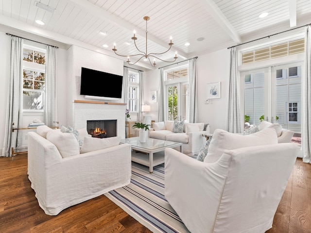 223 Western Lake Dr, Santa Rosa Beach, FL 32459 - living room featuring a lit fireplace, dark wood-style floors, a chandelier, and beamed ceiling