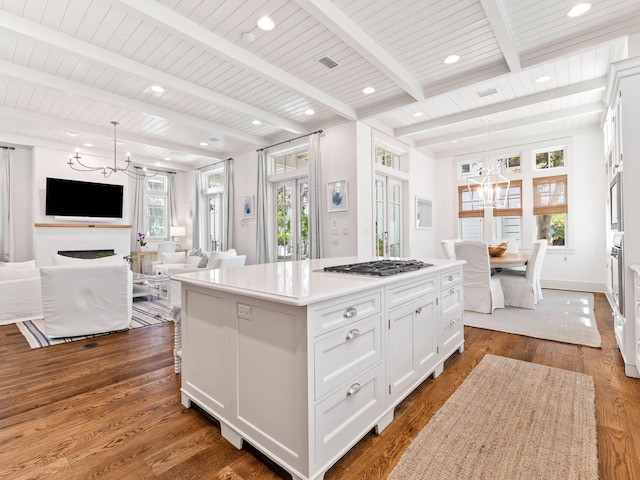 223 Western Lake Dr, Santa Rosa Beach, FL 32459 - kitchen featuring dark wood-type flooring, white cabinetry, appliances with stainless steel finishes, and a chandelier