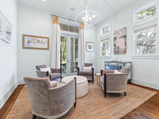 223 Western Lake Dr, Santa Rosa Beach, FL 32459 - living area featuring crown molding, french doors, baseboards, dark wood-type flooring, and an inviting chandelier