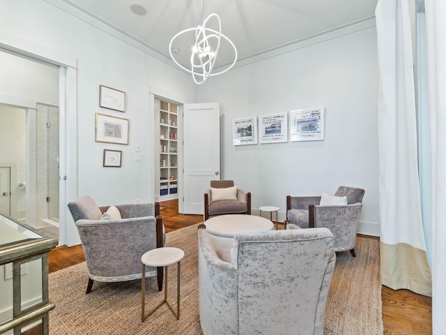 223 Western Lake Dr, Santa Rosa Beach, FL 32459 - sitting room featuring wood finished floors, ornamental molding, and an inviting chandelier