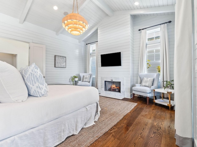 223 Western Lake Dr, Santa Rosa Beach, FL 32459 - bedroom with vaulted ceiling with beams, a warm lit fireplace, wood walls, and dark wood-type flooring