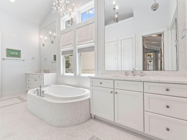 223 Western Lake Dr, Santa Rosa Beach, FL 32459 - full bathroom featuring vaulted ceiling, an inviting chandelier, a sink, two vanities, and a bath
