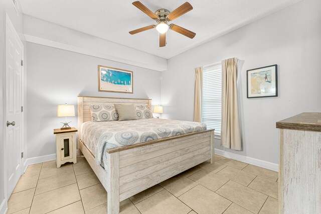 bedroom featuring light tile patterned floors, ceiling fan, and baseboards