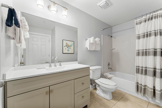 bathroom featuring visible vents, toilet, shower / bath combo, tile patterned flooring, and vanity