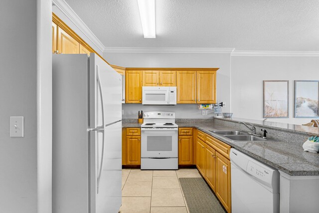 kitchen featuring a sink, white appliances, ornamental molding, and light tile patterned floors