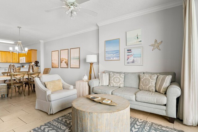 living area with light tile patterned floors, ceiling fan with notable chandelier, a textured ceiling, and ornamental molding