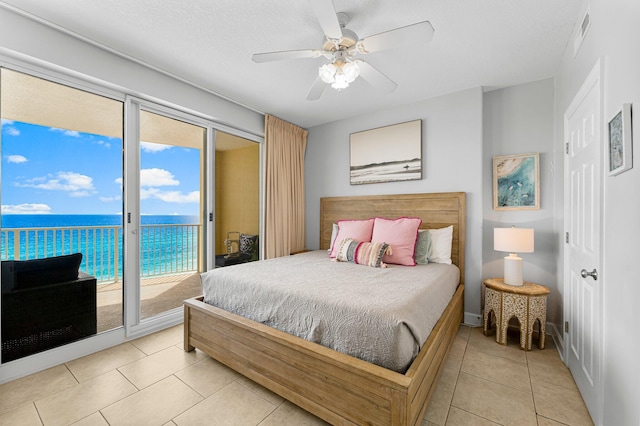 bedroom with visible vents, a water view, a ceiling fan, light tile patterned floors, and access to exterior