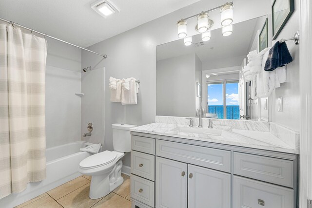 bathroom featuring toilet, shower / bath combination with curtain, vanity, and tile patterned flooring