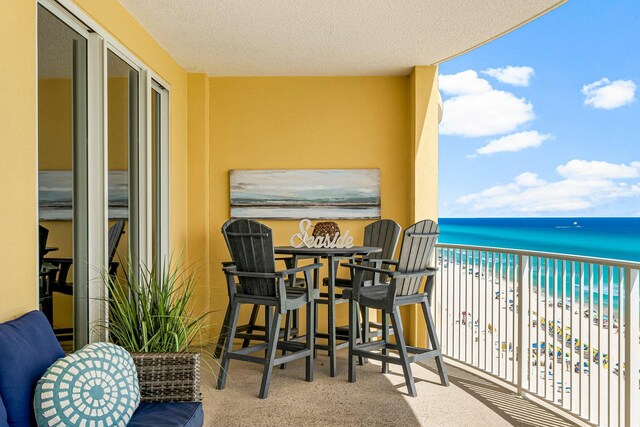 balcony with a view of the beach and a water view