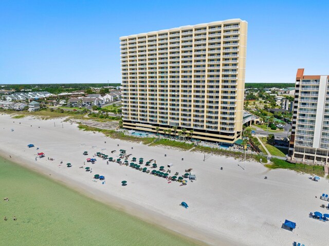 exterior space featuring a water view and a beach view