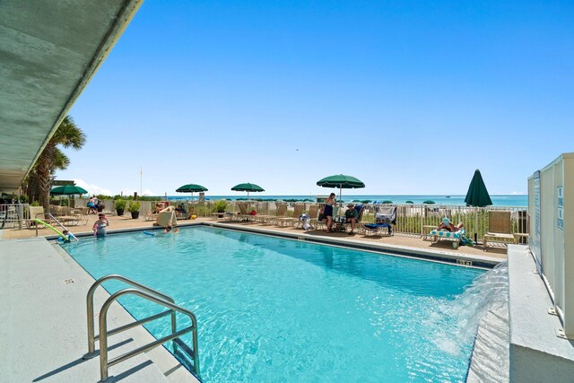 pool featuring fence and a patio area
