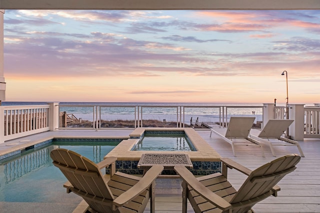 outdoor pool featuring a view of the beach and a water view