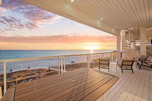 wooden terrace with a beach view and a water view