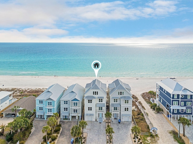 bird's eye view featuring a water view, a beach view, and a residential view