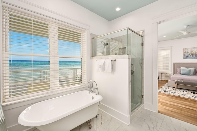 ensuite bathroom featuring a soaking tub, marble finish floor, a stall shower, and ensuite bathroom