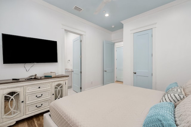 bedroom featuring visible vents, ornamental molding, recessed lighting, connected bathroom, and dark wood-style flooring