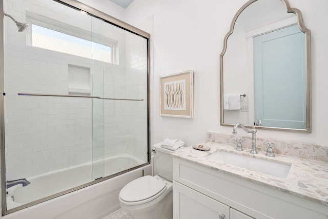 full bath featuring combined bath / shower with glass door, toilet, and vanity