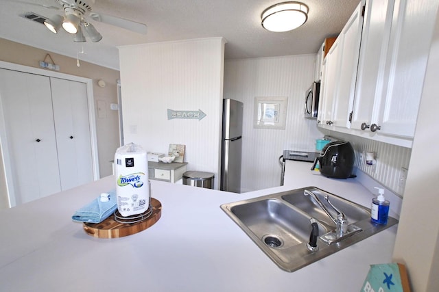775 Gulf Shore Dr Unit 8108, Destin, FL 32541 - kitchen featuring ceiling fan, light countertops, stainless steel appliances, white cabinetry, and a sink