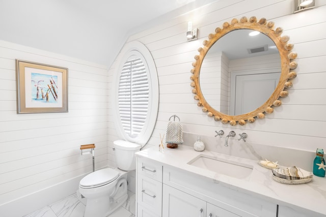 bathroom featuring toilet, vanity, lofted ceiling, marble finish floor, and visible vents