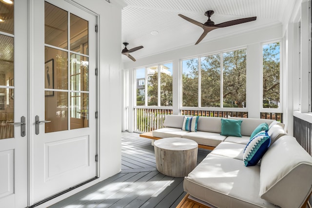 sunroom / solarium featuring an outdoor living space, ceiling fan, and french doors