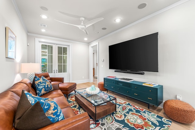 living area with french doors, wood finished floors, ornamental molding, and visible vents