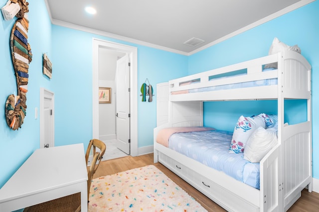 bedroom with visible vents, baseboards, ornamental molding, wood finished floors, and recessed lighting