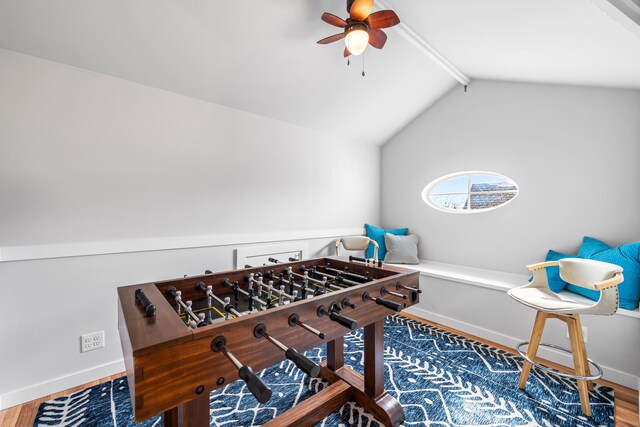 game room with baseboards, vaulted ceiling with beams, wood finished floors, and ceiling fan