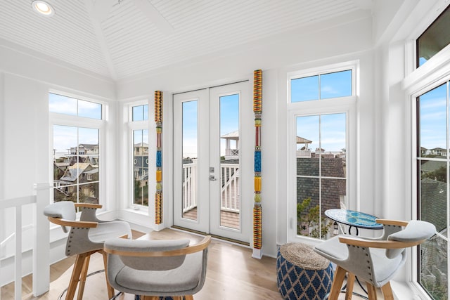 sunroom / solarium featuring french doors and a healthy amount of sunlight
