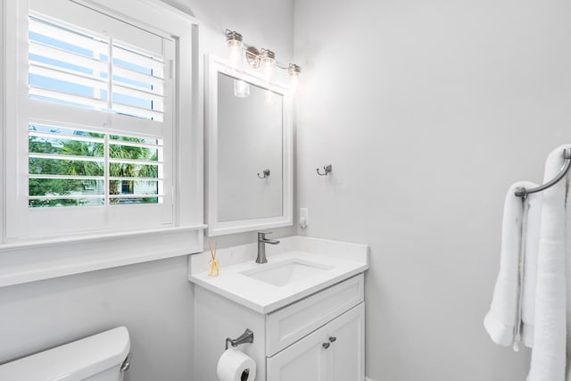 half bathroom featuring toilet and vanity