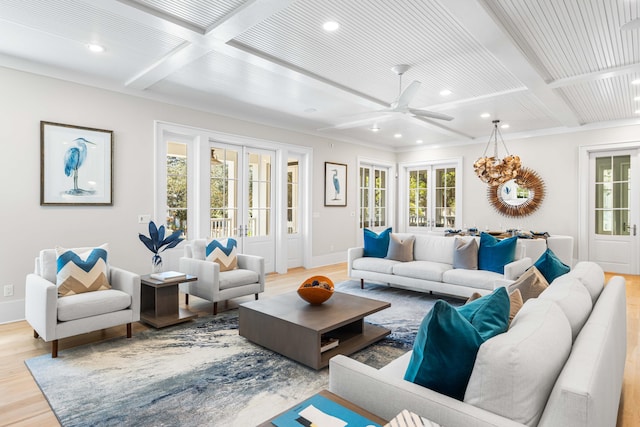 living area with beamed ceiling, coffered ceiling, a ceiling fan, and light wood finished floors