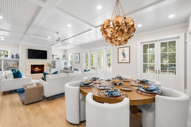 dining space featuring coffered ceiling, french doors, a fireplace, light wood-style floors, and recessed lighting