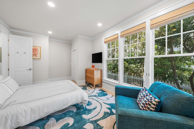 bedroom featuring baseboards, crown molding, and recessed lighting