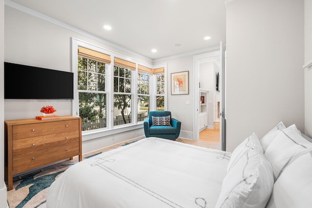 bedroom featuring wood finished floors, ornamental molding, multiple windows, and recessed lighting