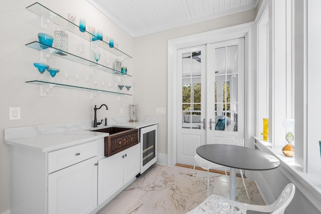 bar featuring wet bar, wine cooler, french doors, a sink, and marble finish floor