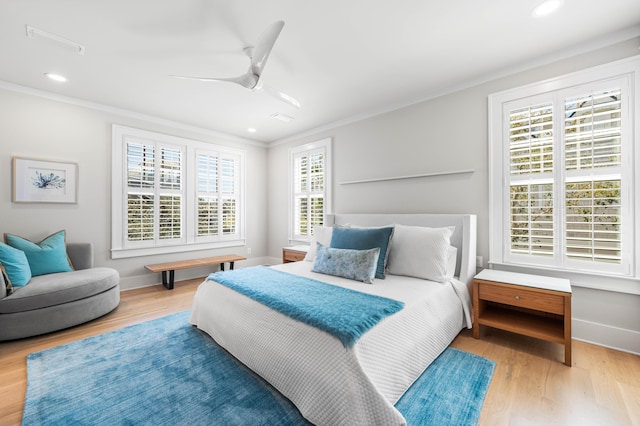 bedroom featuring baseboards, wood finished floors, and ornamental molding