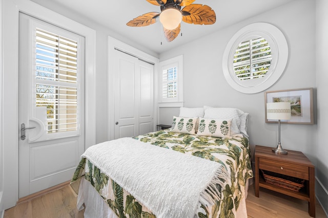 bedroom with a closet, wood finished floors, and a ceiling fan