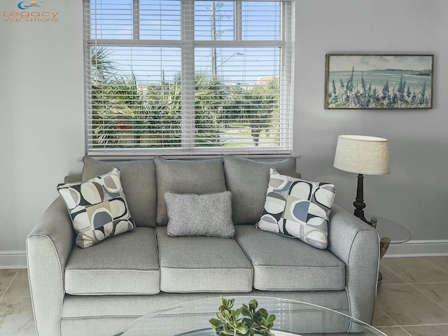 tiled living area with baseboards