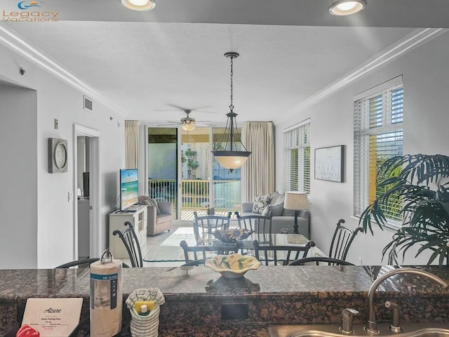 dining room with visible vents, ceiling fan, and ornamental molding