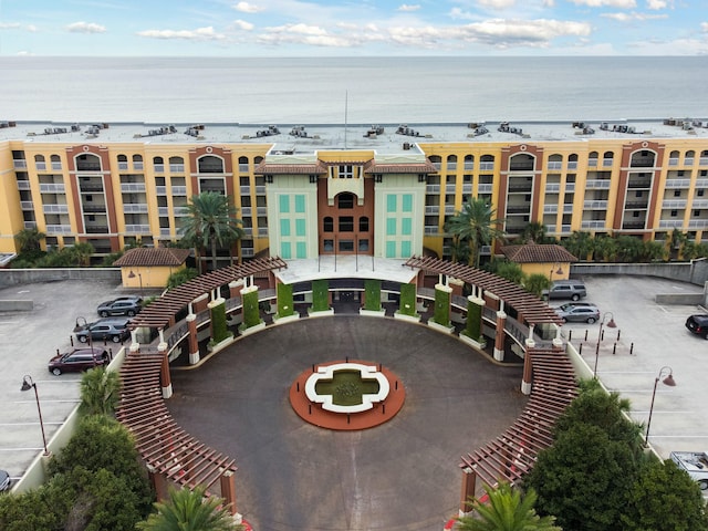exterior space featuring a water view and uncovered parking