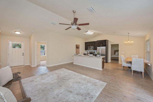 3362 Peeble Dr, Crestview, FL 32539 - living area featuring lofted ceiling, light wood-type flooring, a chandelier, ceiling fan, and baseboards