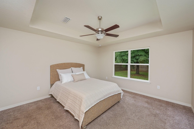 3362 Peeble Dr, Crestview, FL 32539 - carpeted bedroom featuring a tray ceiling, baseboards, and a ceiling fan