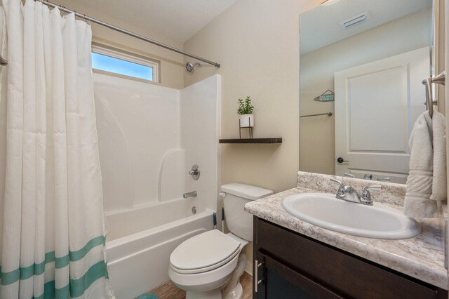 3362 Peeble Dr, Crestview, FL 32539 - bathroom featuring shower / bathtub combination with curtain, vanity, toilet, and wood finished floors