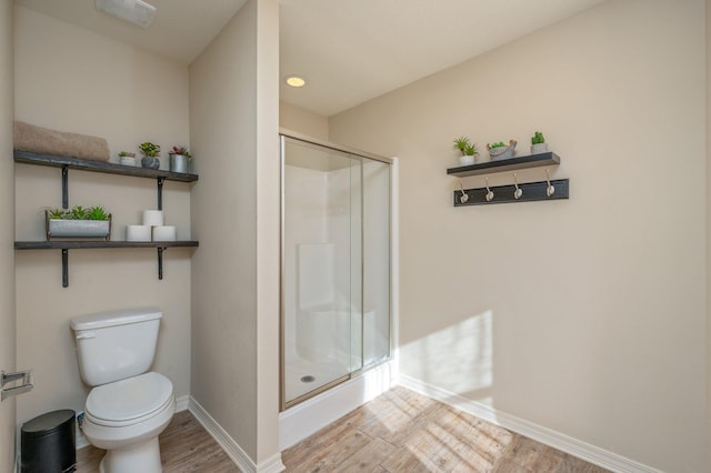 3362 Peeble Dr, Crestview, FL 32539 - full bath with wood finished floors, a stall shower, baseboards, and toilet